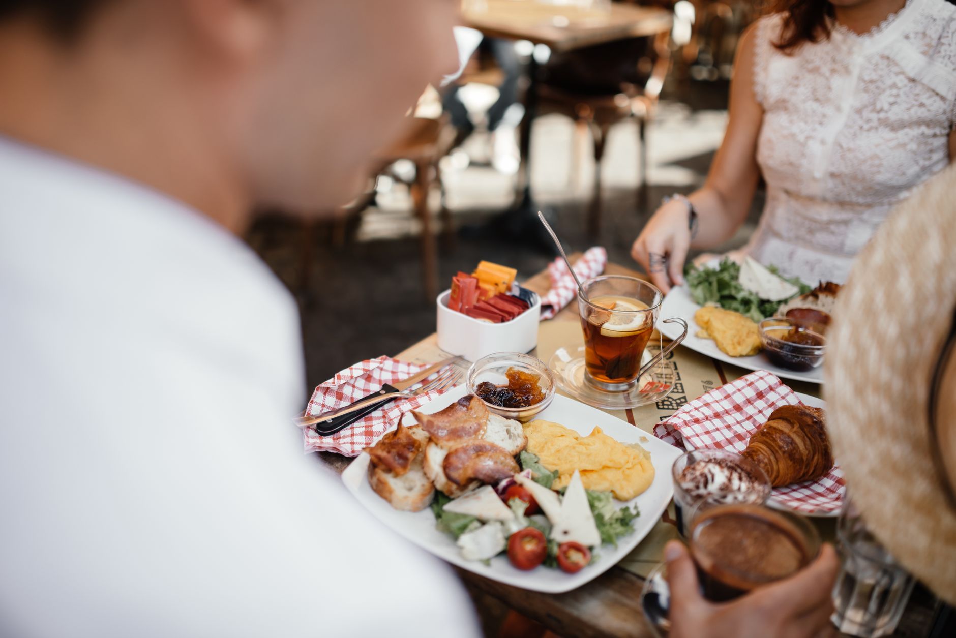 Friends sharing plates and drinks around a brunch table
