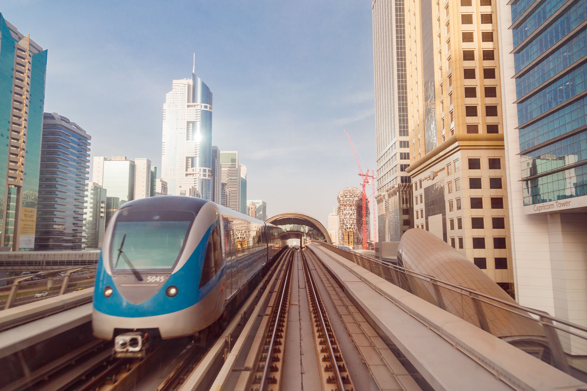 A Dubai Metro train on its elevated track running through the city
