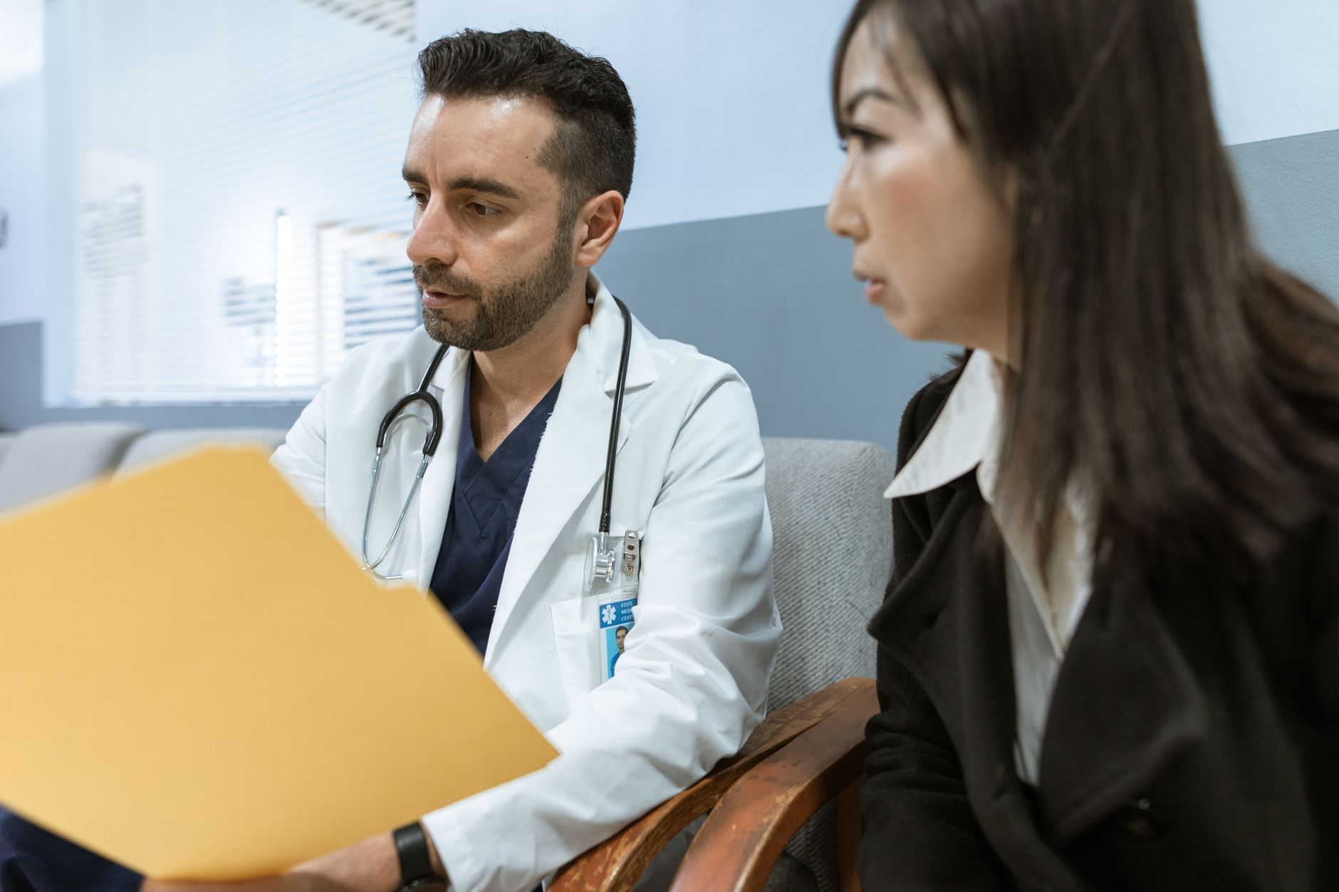 A doctor reviewing records with a patient in a clinic