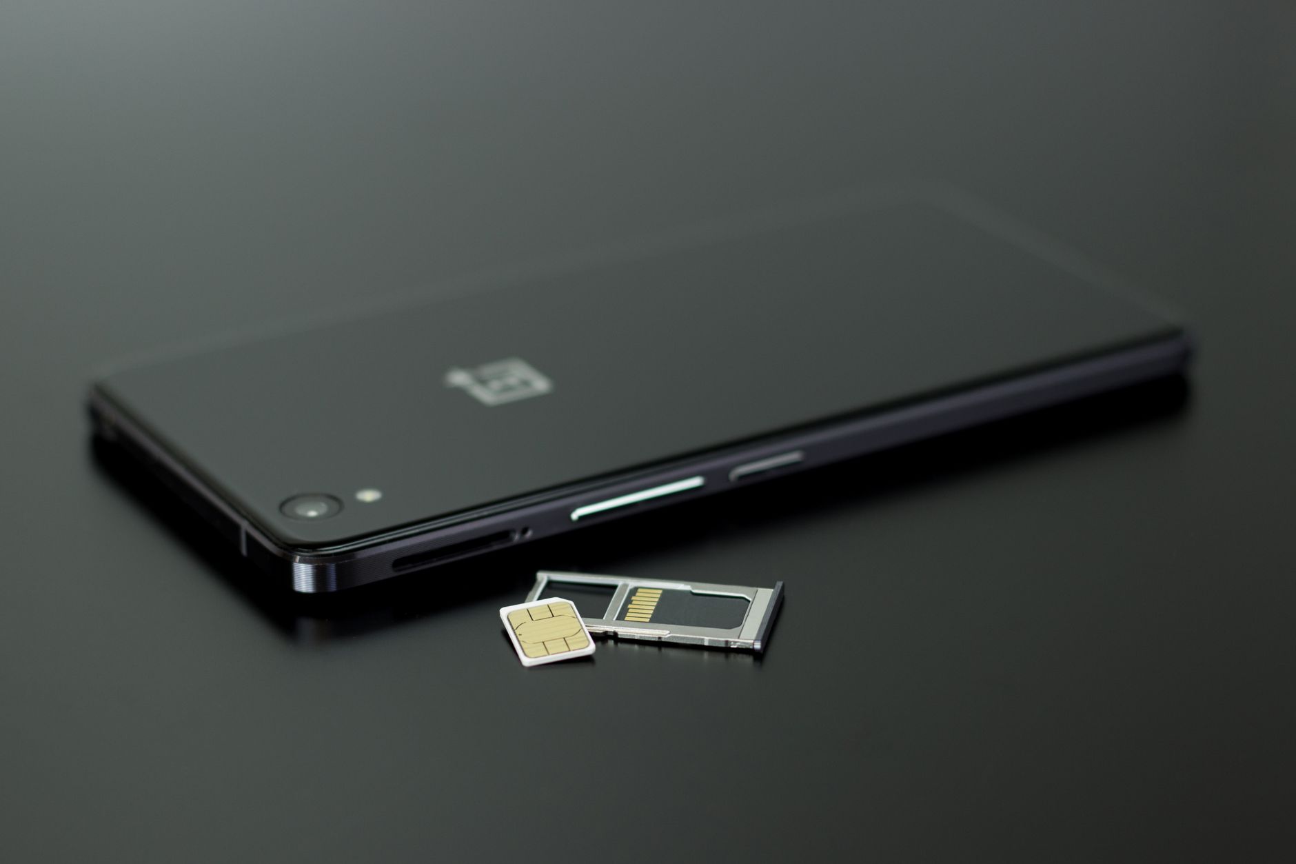 A SIM card resting on a smartphone